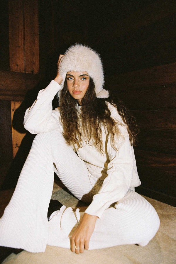 Model wearing a Snuggle Hood in almond color, styled with a cozy outfit.