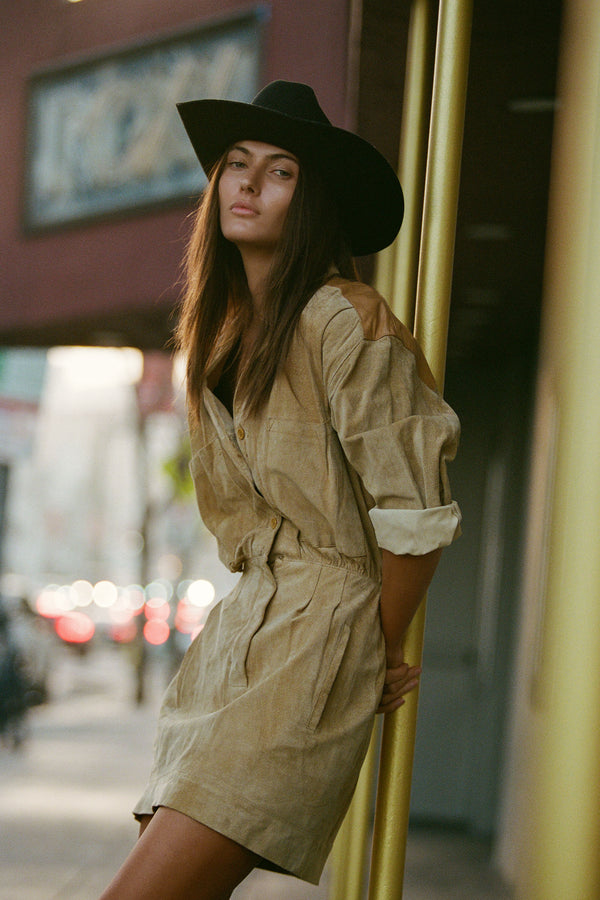 Model wearing The Ridge black wool felt cowboy hat in urban setting